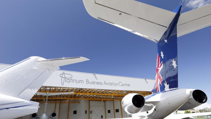 An airplane on the ramp in front of an FBO