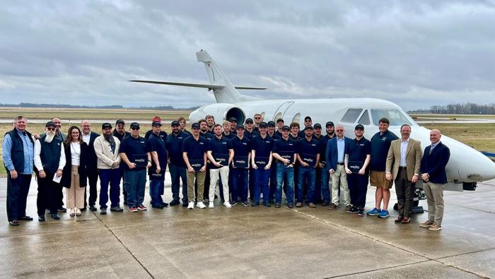 Cohort 3 standing in front of a business jet 