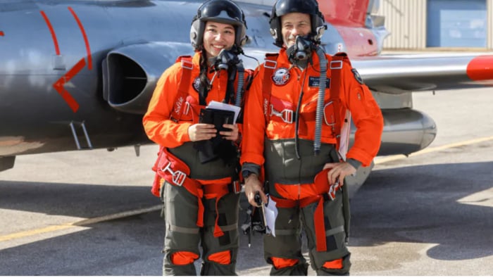 Instructor and student standing in front of aeroplane 