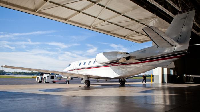 An aircraft being tugged out of a Toledo Jet hangar