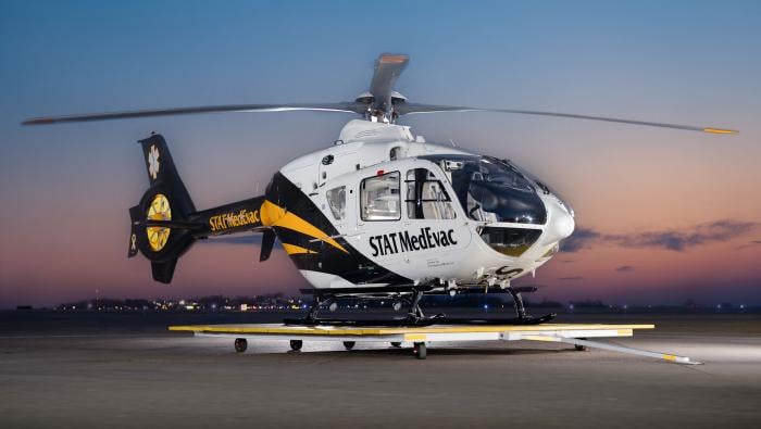 A helicopter on a launch pad at dusk
