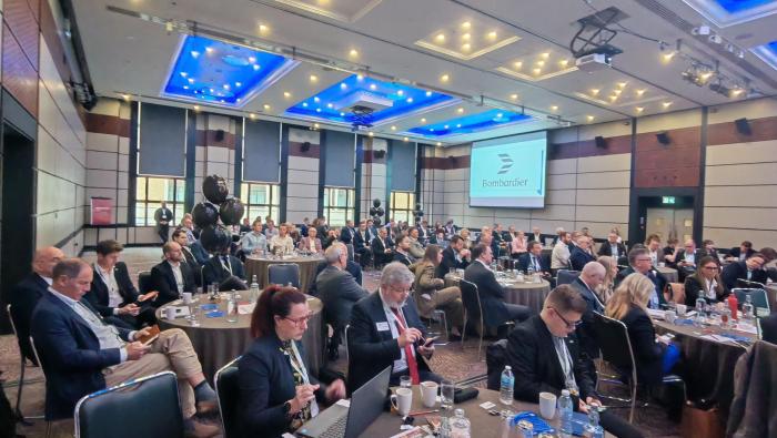 Conference room with delegates sitting at tables 