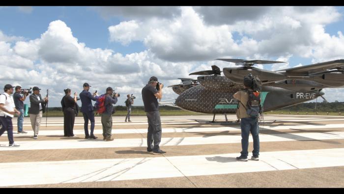 Journalists taking photos of Eve eVTOL on the tarmac 