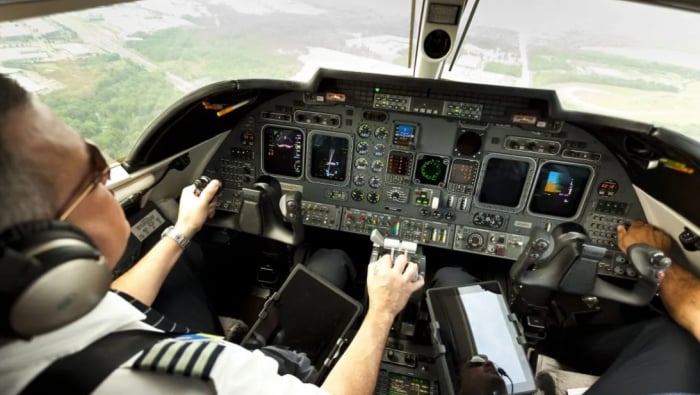 Over-shoulder view of two pilots in cockpit 