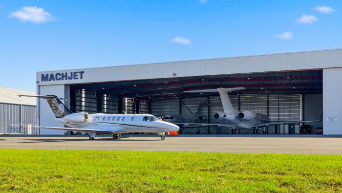 jet on ramp outside hangar