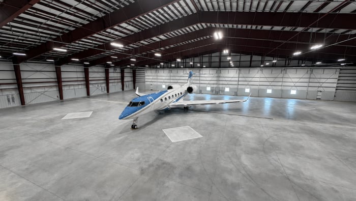 Lone business jet in large hangar