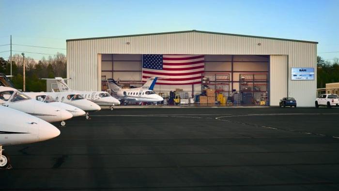 Sky Aircraft Maintenance hangar from the ramp with aircraft parked in front