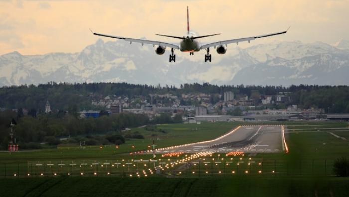 An airplane lands at Zurich Switzerland at dusk
