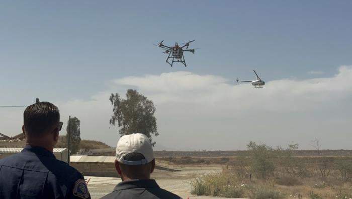A drone and helicopter avoid each other
