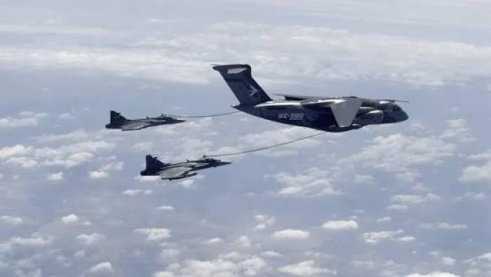 KC-390 with two Gripen receiving fuel mid-air 