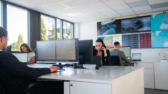 Workers look at computers in an office