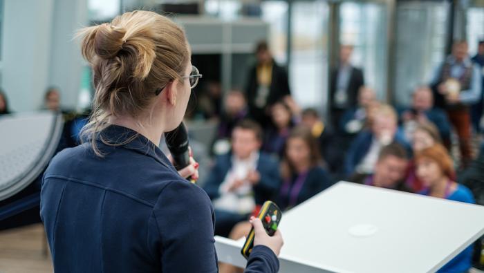woman pitching in front of audience