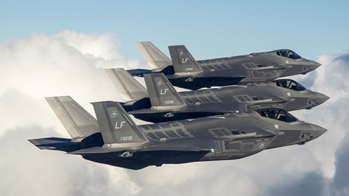 Formation of three F-35As against clouds 