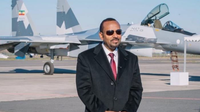Prime minister standing in front of Su-35