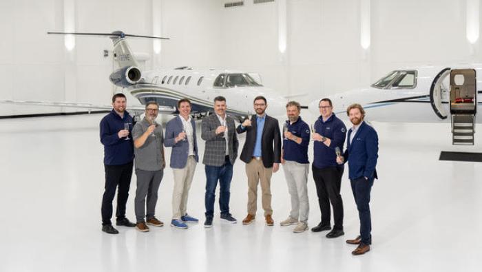 CJ4 Gen 2 in hangar with group of people standing in foreground