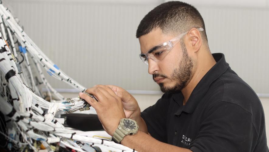 Duncan Aviation Houston satellite avionics technician Joshua Hernandez building a wiring harness