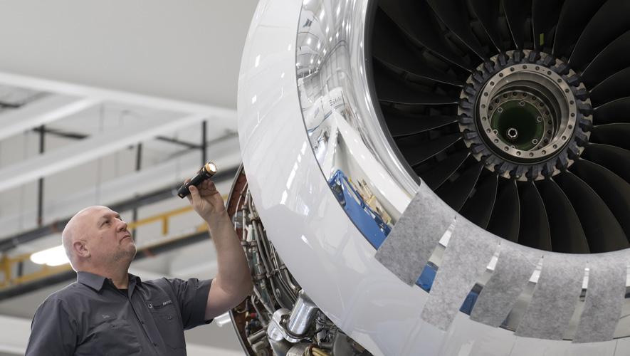 Western Aircraft technician examining engine