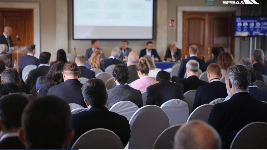 Room of delegates sit in presentation 
