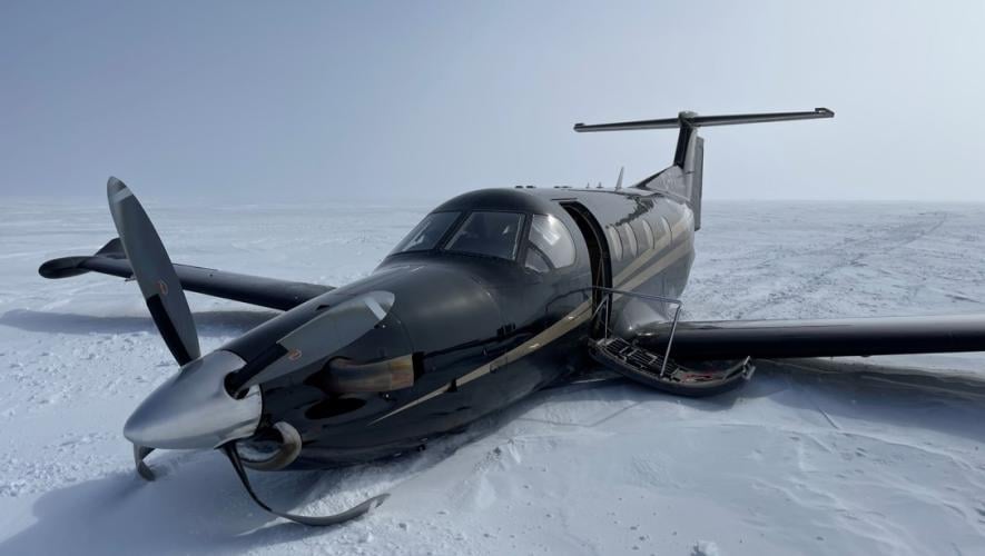 The aircraft landed on its belly on the sea ice, which was covered in a layer of snow