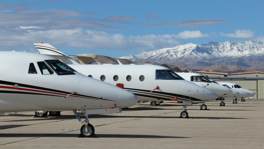 Business jets parked on ramp