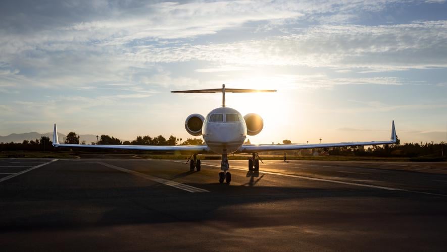 parked jet at sunset