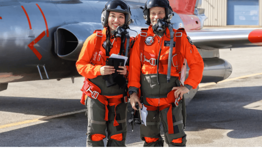 Instructor and student standing in front of aeroplane 