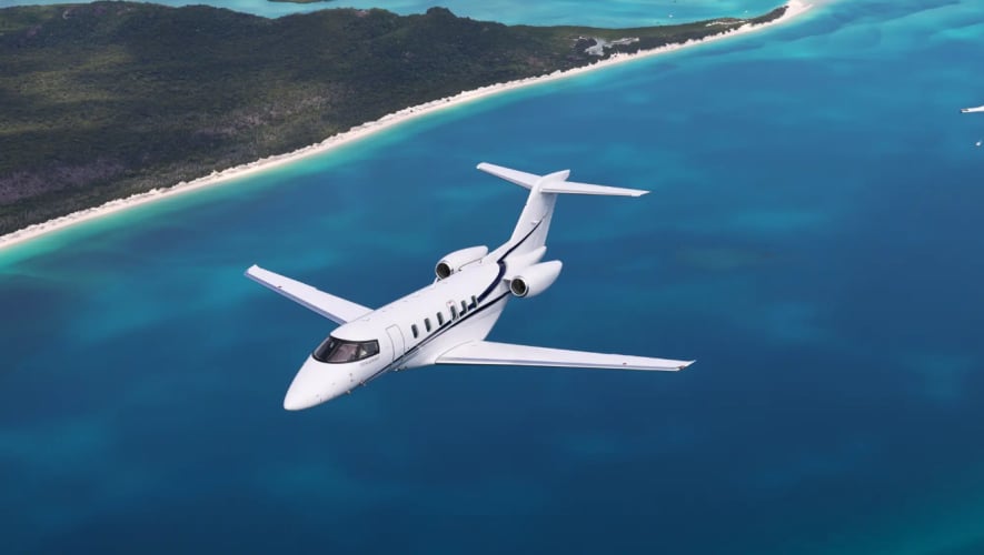 PC-24 flying over blue ocean 