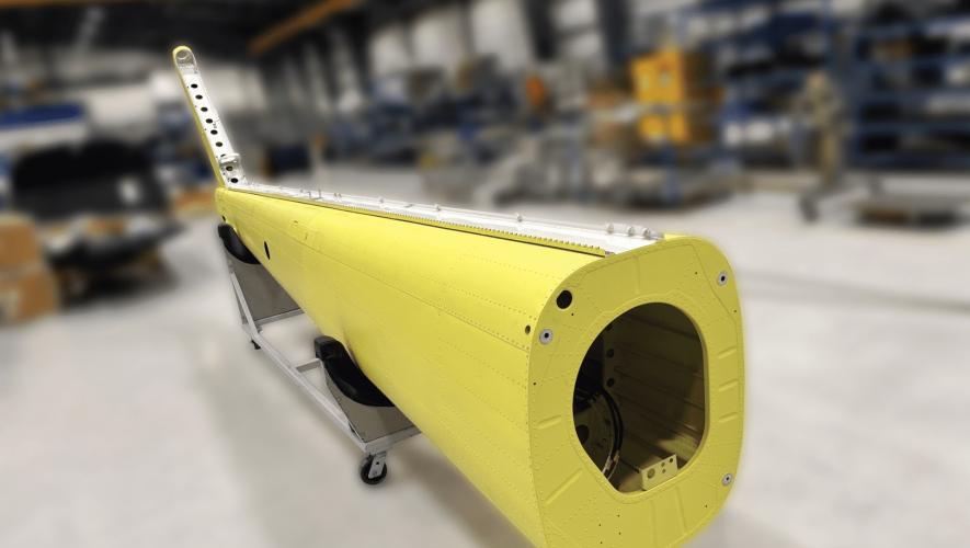 An image of the tailboom modification in a maintenance hangar