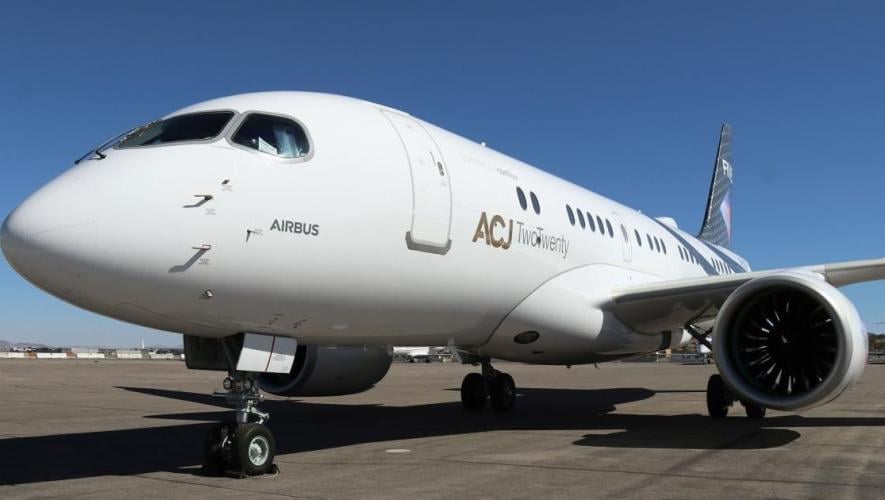 White ACJ TwoTwenty parked on ramp 