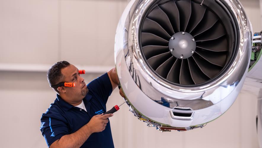 Technician examining engine