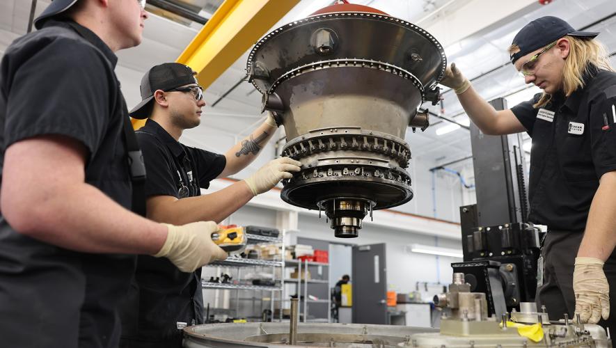 Duncan Aviation technicians working on a PW308 engine