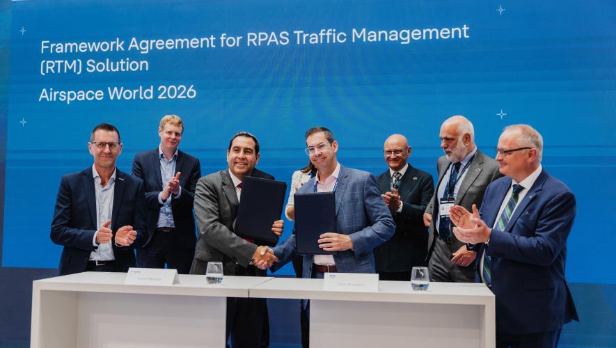 Indra Group executive vice president of ATM Victor Martínez, left, and Nav Canada vice president and chief technology and information officer David Sheppard shake hands at the rFIMS agreement signing at Airspace World 2026 in Lisbon on May 26. Also pictured are Nav Canada president and CEO Mark Cooper and RPAS Traffic Management director Alan Chapman. 
