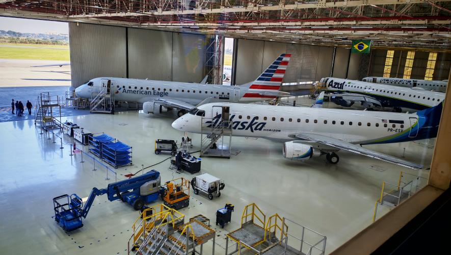 Three E-Jets in hangar with open door 