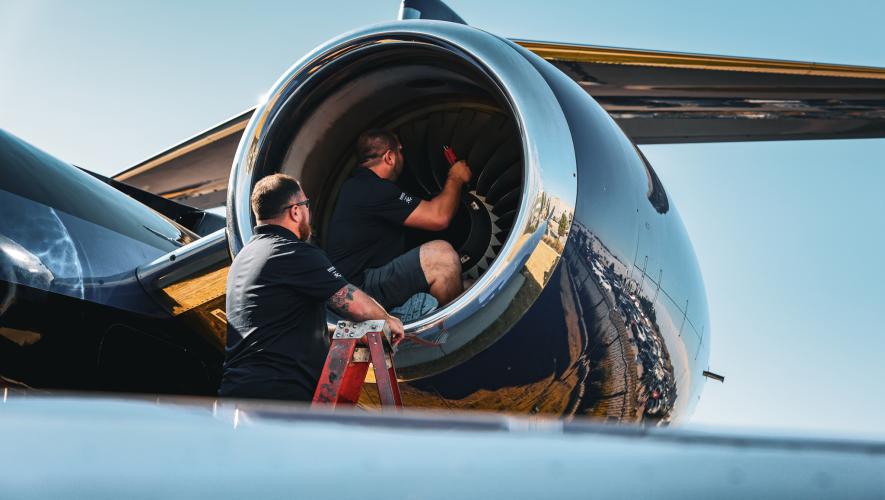 Duncan Aviation AOG technicians examining aircraft engine