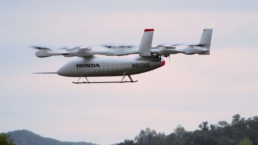 Honda's full-scale eVTOL technology demonstrator, registration N805HX, in flight over San Luis Obispo, California. The white aircraft features eight lift rotors and a pusher propeller at the tail.