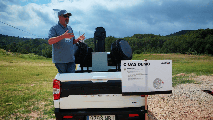 Samurai system mounted onto the back of a pickup truck in a field
