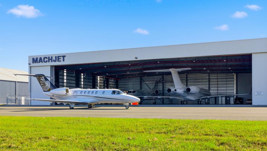 jet on ramp outside hangar