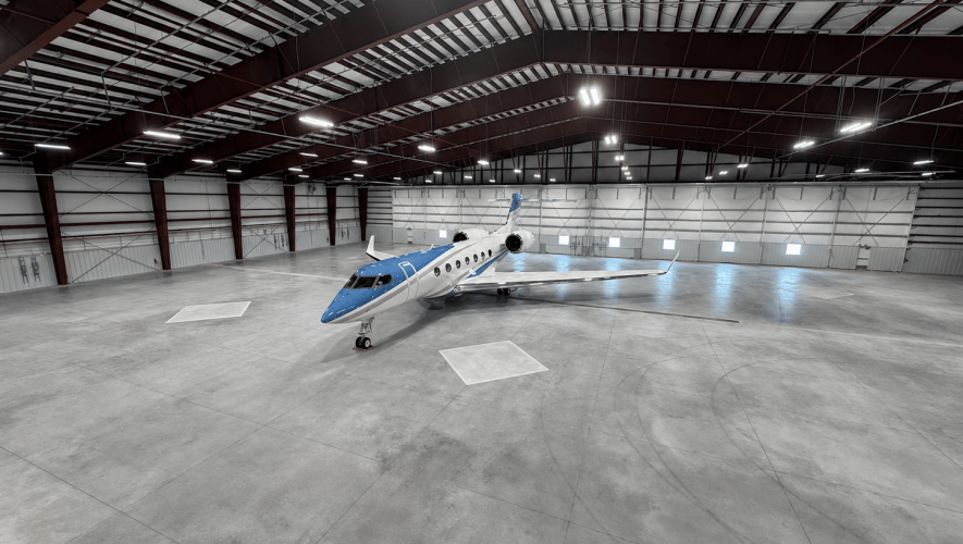 Lone business jet in large hangar