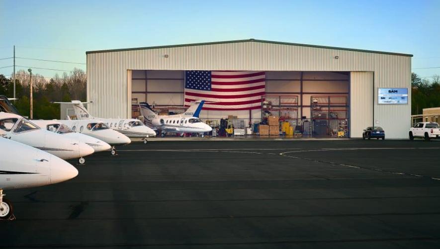 Sky Aircraft Maintenance hangar from the ramp with aircraft parked in front