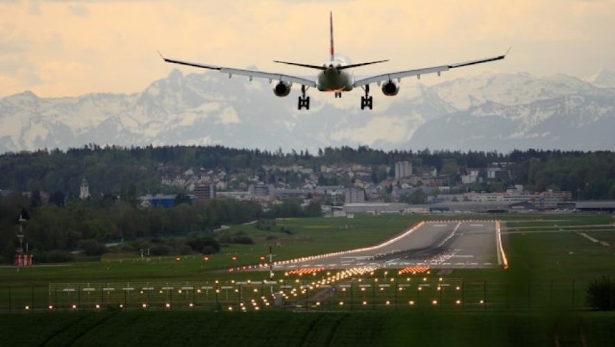 An airplane lands at Zurich Switzerland at dusk