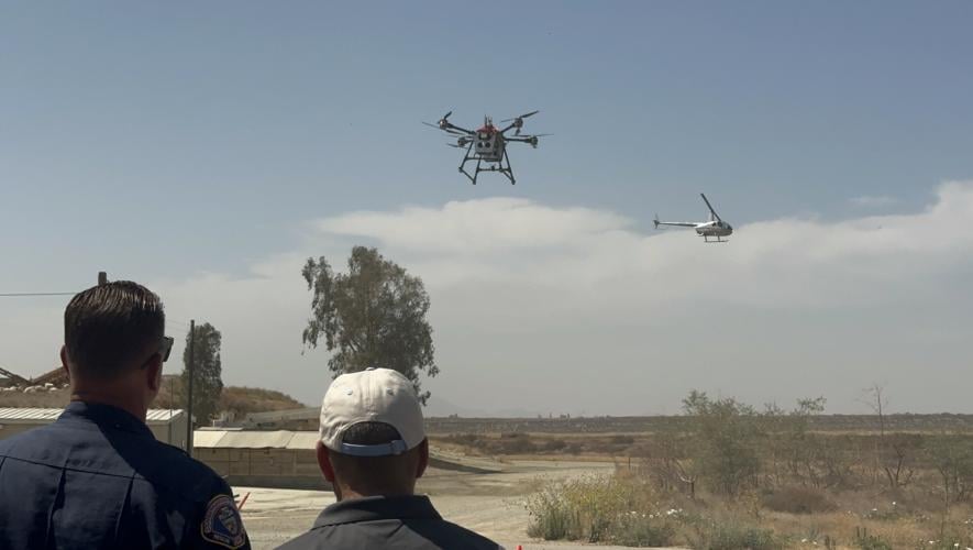A drone and helicopter avoid each other