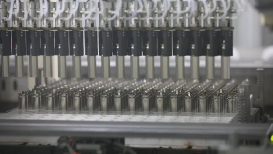 Rows of cylindrical battery cells on a production line