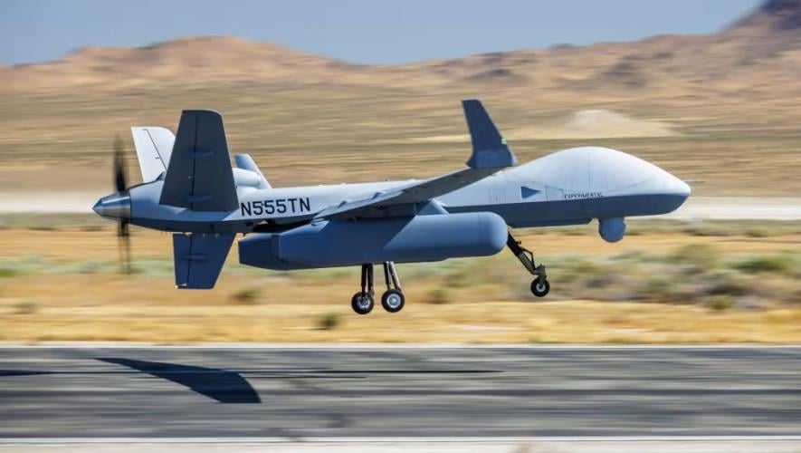 MQ-9 taking off from runway in desert 
