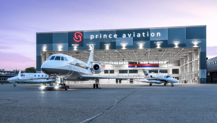 Hangar in sunset with open door, three aircraft