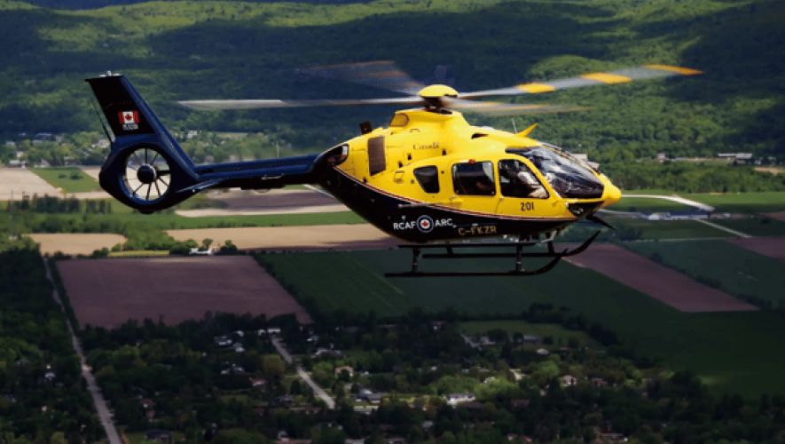 Yellow and black H135 in flight, Canadian civil registration