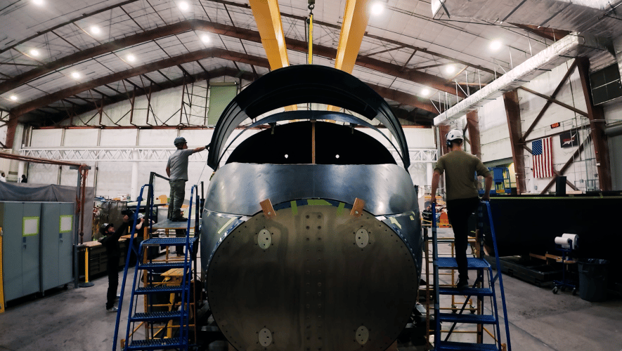 Workers at Scaled Composites line up an upper panel on Jet1’s forward fuselage.