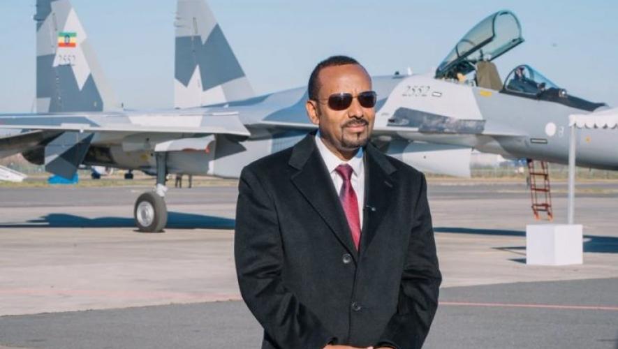 Prime minister standing in front of Su-35