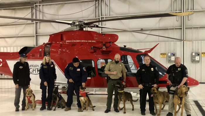K9 handlers with their charges by helicopter