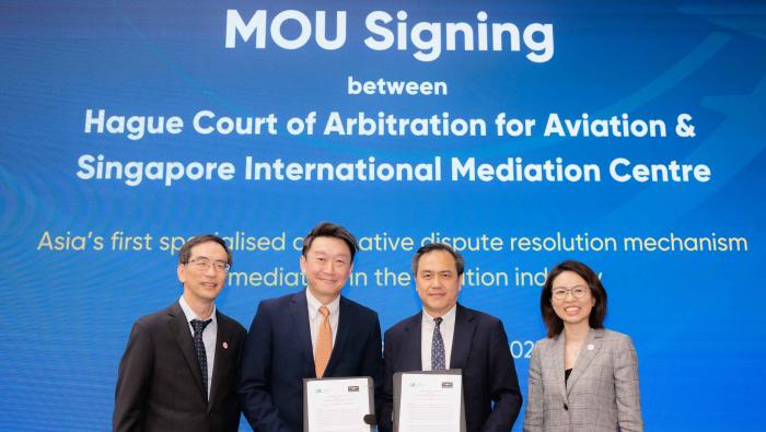 The Hague CAA and the Singapore International Mediation Centre signing