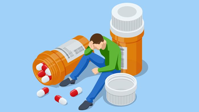 Man surrounded by pills